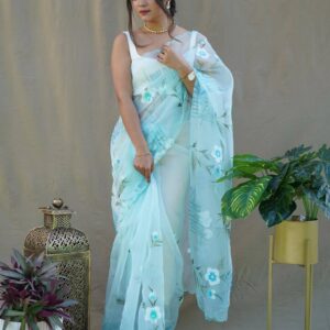 Woman wearing floral blue organza saree – pastel lightweight designer saree look